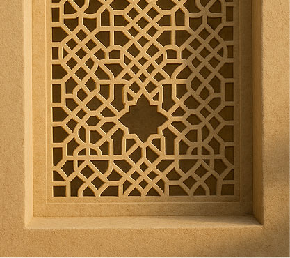 Traditional Emirati-style mashrabiya in warm sand-colored stone