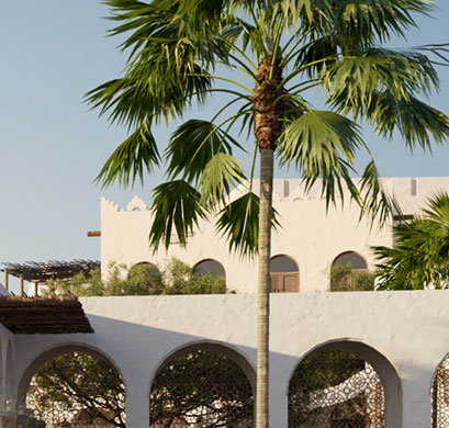 Date palms beside an arcaded low-rise building in a coastal development